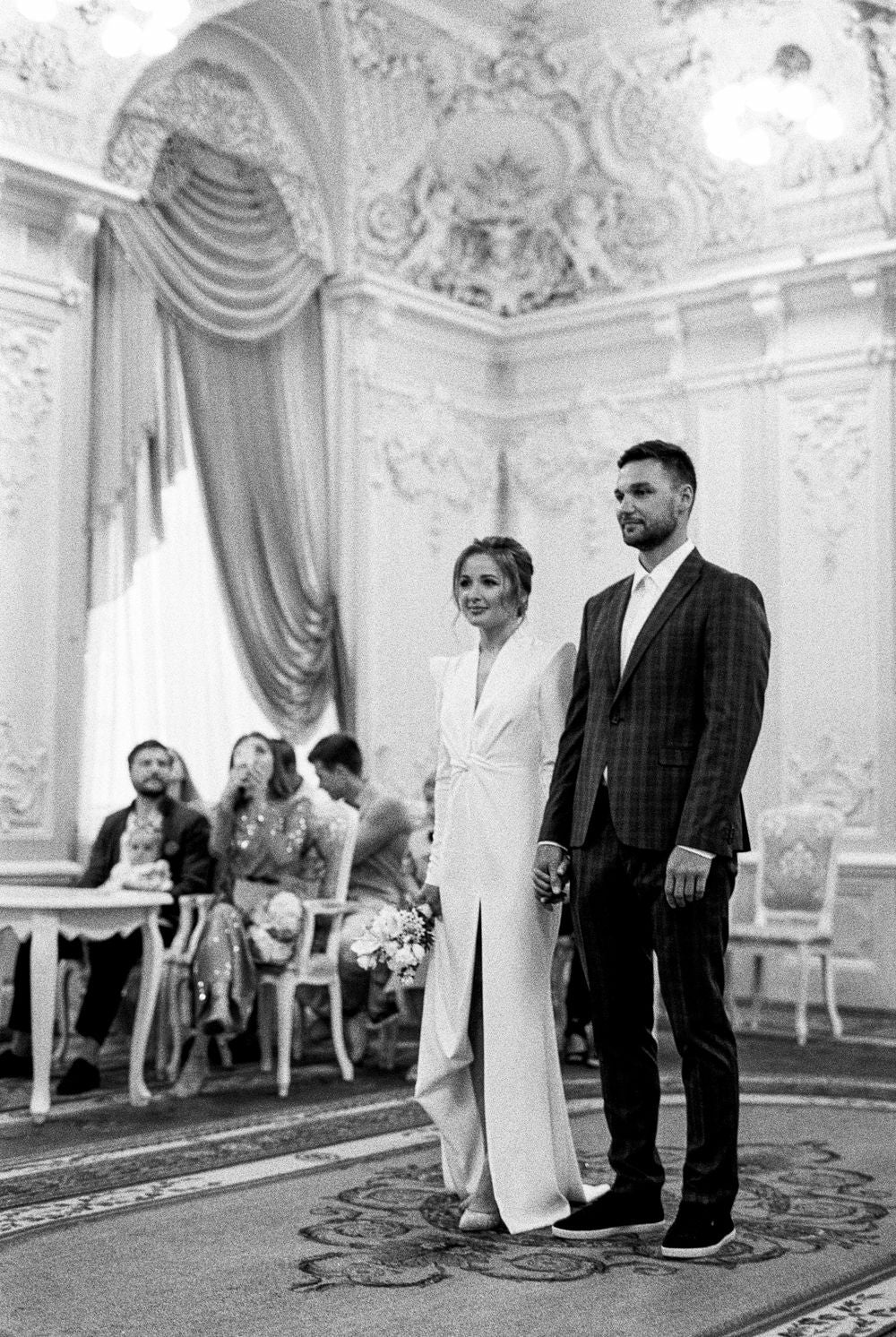 A couple holding hands on their wedding day
